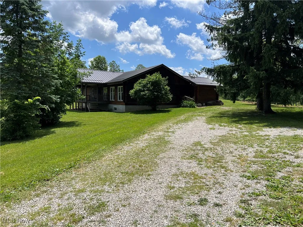 View of side of property with a yard