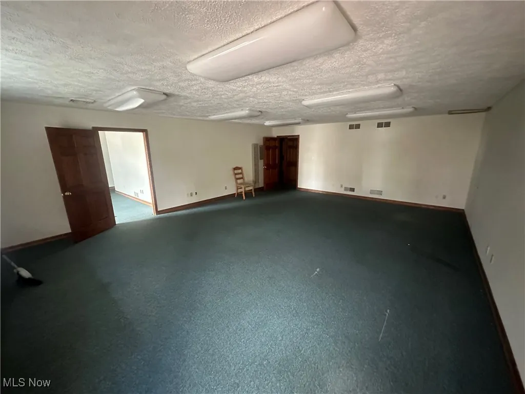 Empty room with a textured ceiling