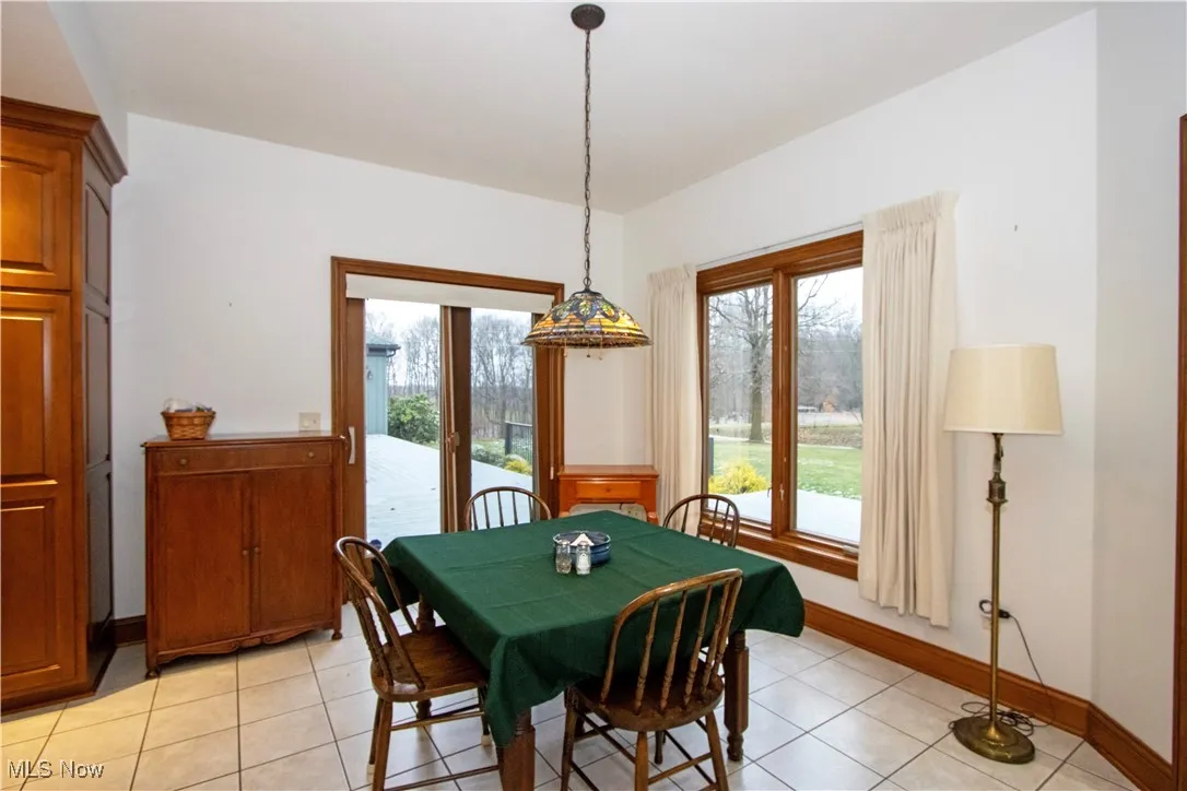 Dining space featuring light tile patterned flooring