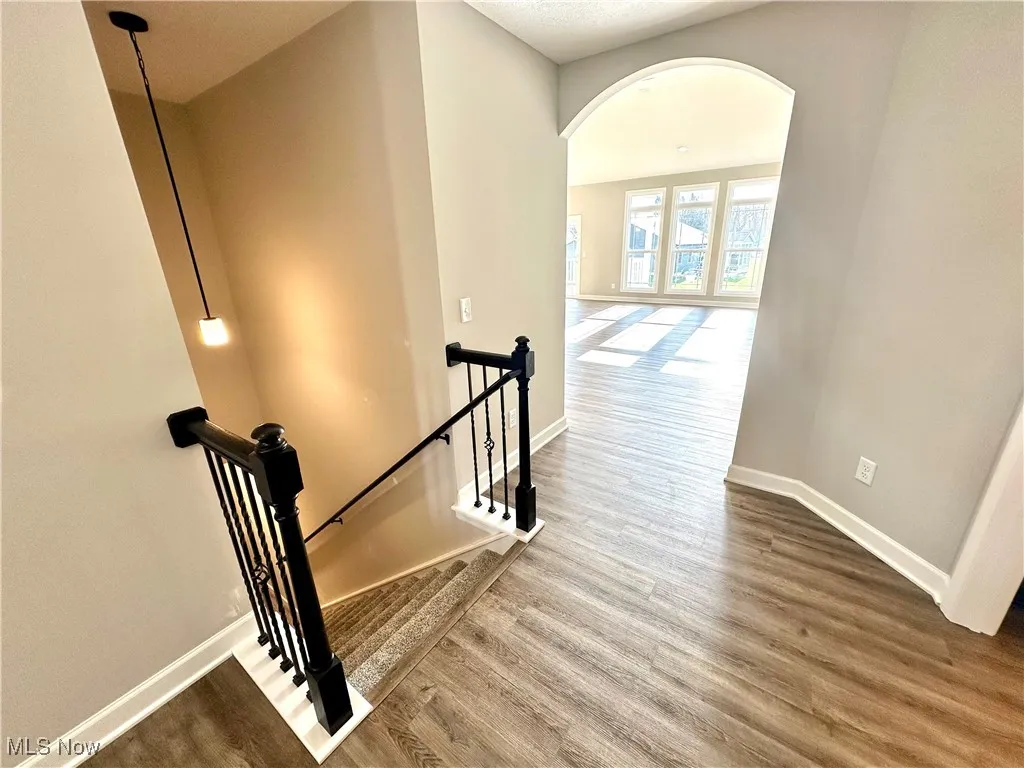 Stairs with hardwood / wood-style flooring