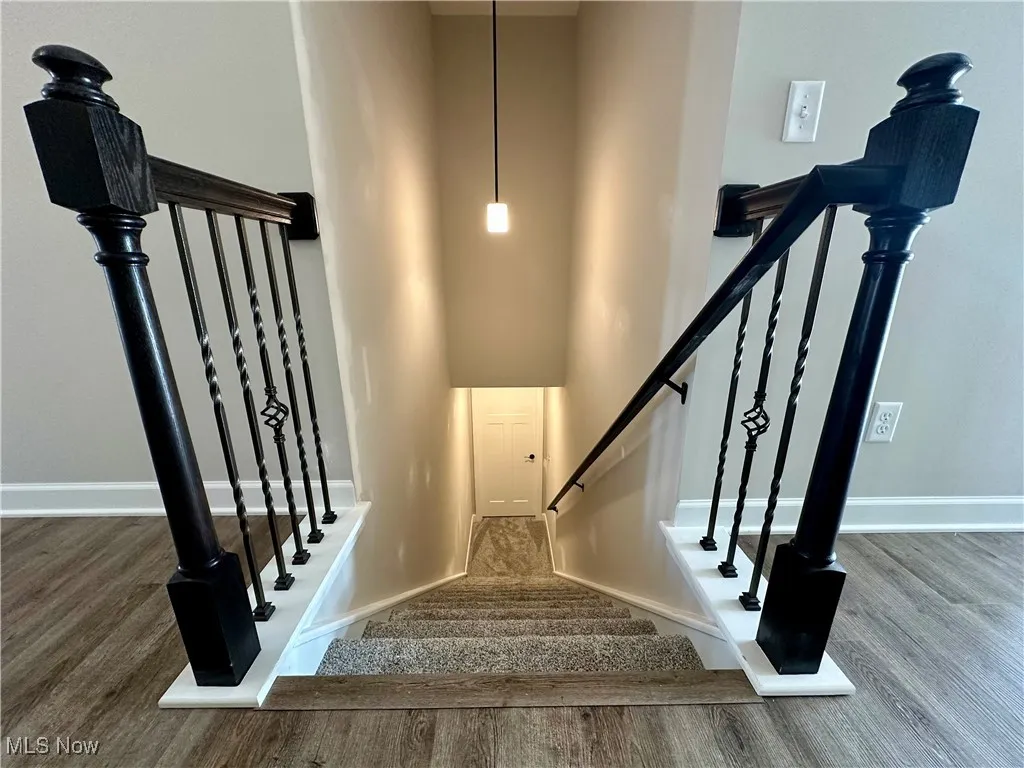 Stairs featuring wood-type flooring