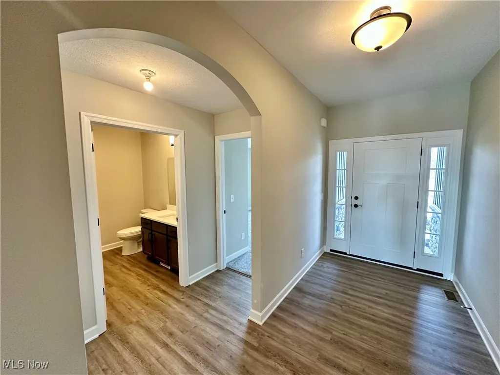 Foyer with hardwood / wood-style floors and a textured ceiling