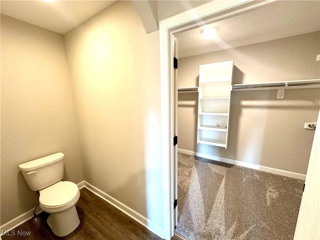 Bathroom with hardwood / wood-style floors and toilet