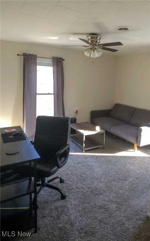 Upper level bedroom with carpet floors, 2 closets, and ceiling fan perfect for office or activity room.