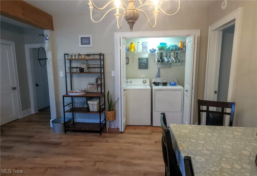 1st floor Laundry closet and dining area with chandelier.