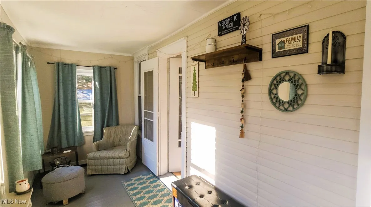 Sitting room/ enclosed porch, perfect for sipping your favorite drink and relaxing and or reading.