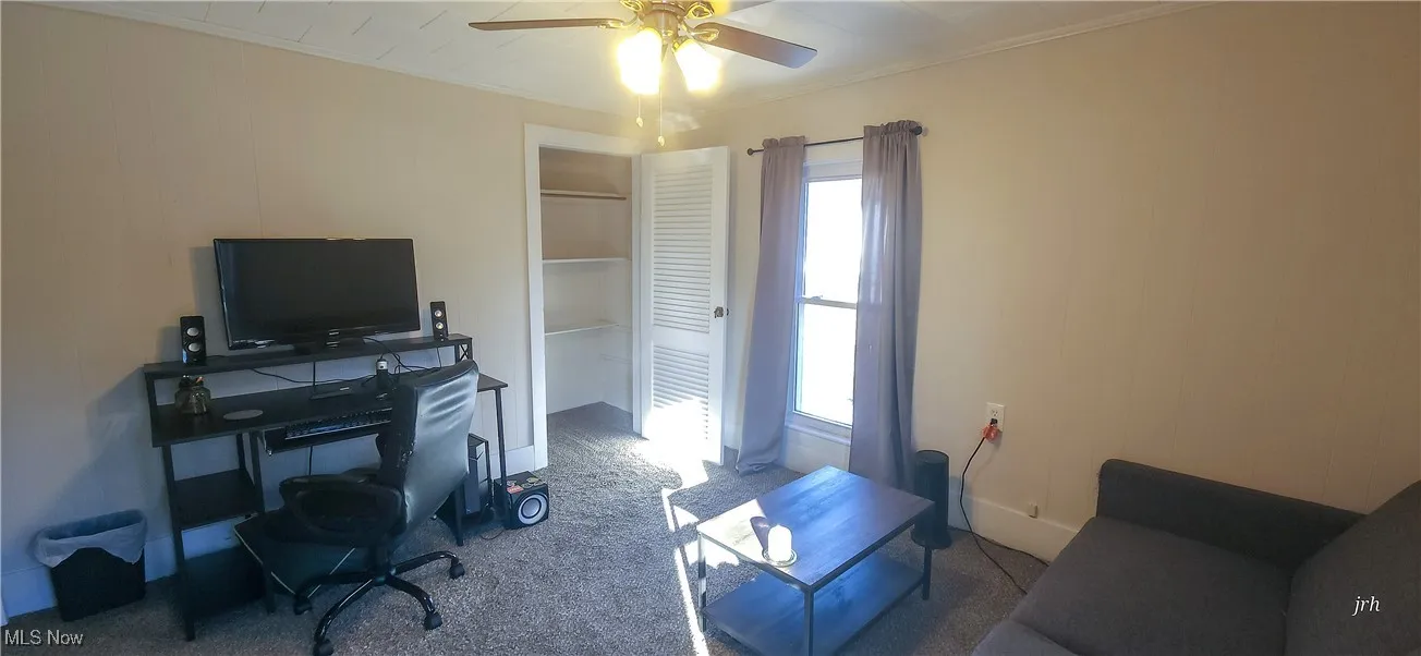 Upper level bedroom  ceiling fan, carpet floors, and 2 closets.