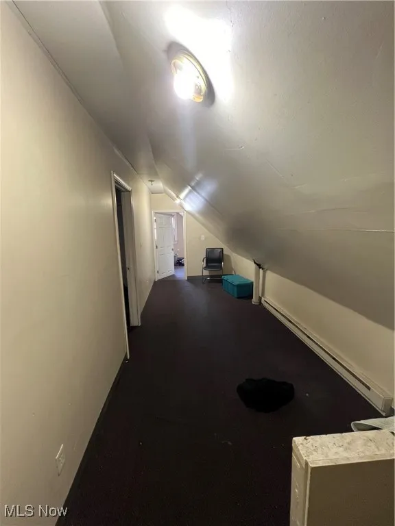 Bonus room featuring baseboard heating and vaulted ceiling