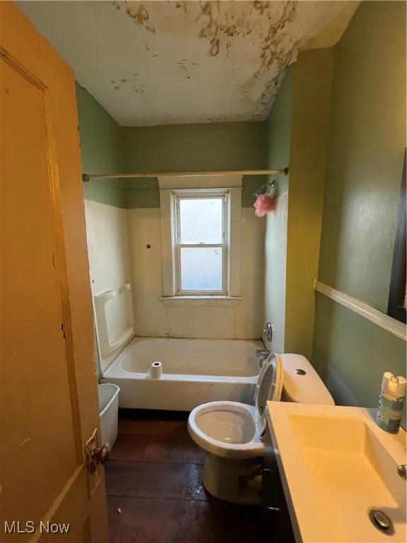 Full bathroom featuring vanity, shower / bathtub combination, and toilet