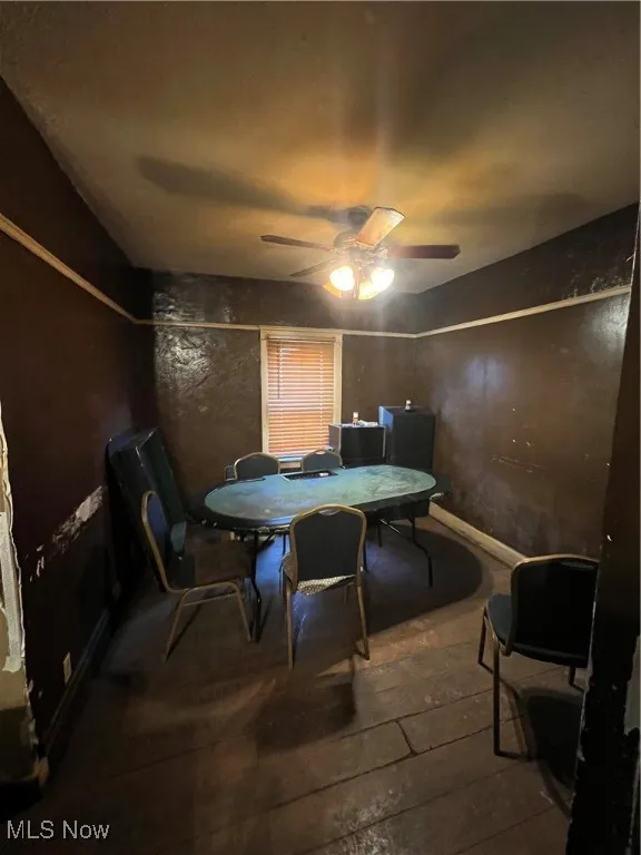 Dining area with hardwood / wood-style flooring and ceiling fan