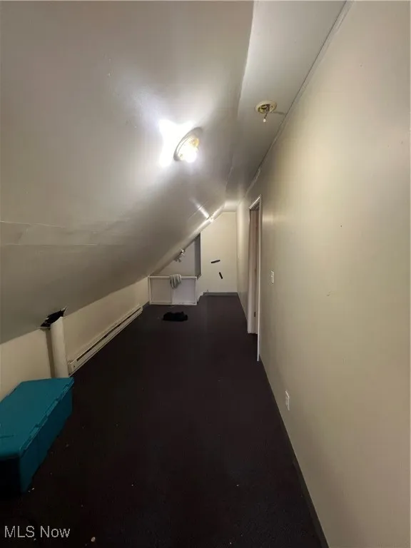 Bonus room with a baseboard radiator and vaulted ceiling