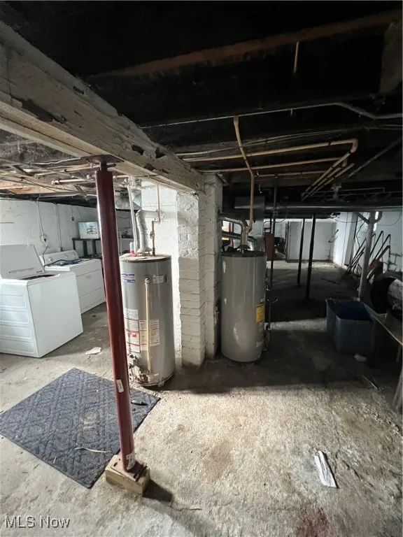 Basement featuring separate washer and dryer and water heater