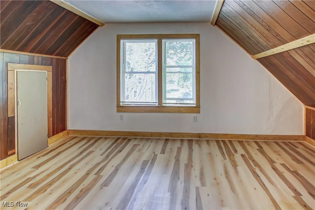 Bonus room featuring lofted ceiling and light hardwood / wood-style flooring