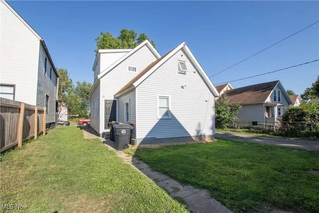 Back of property featuring a yard