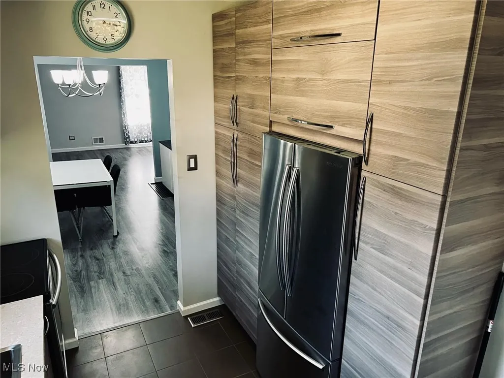 Bathroom featuring tile patterned floors and a chandelier