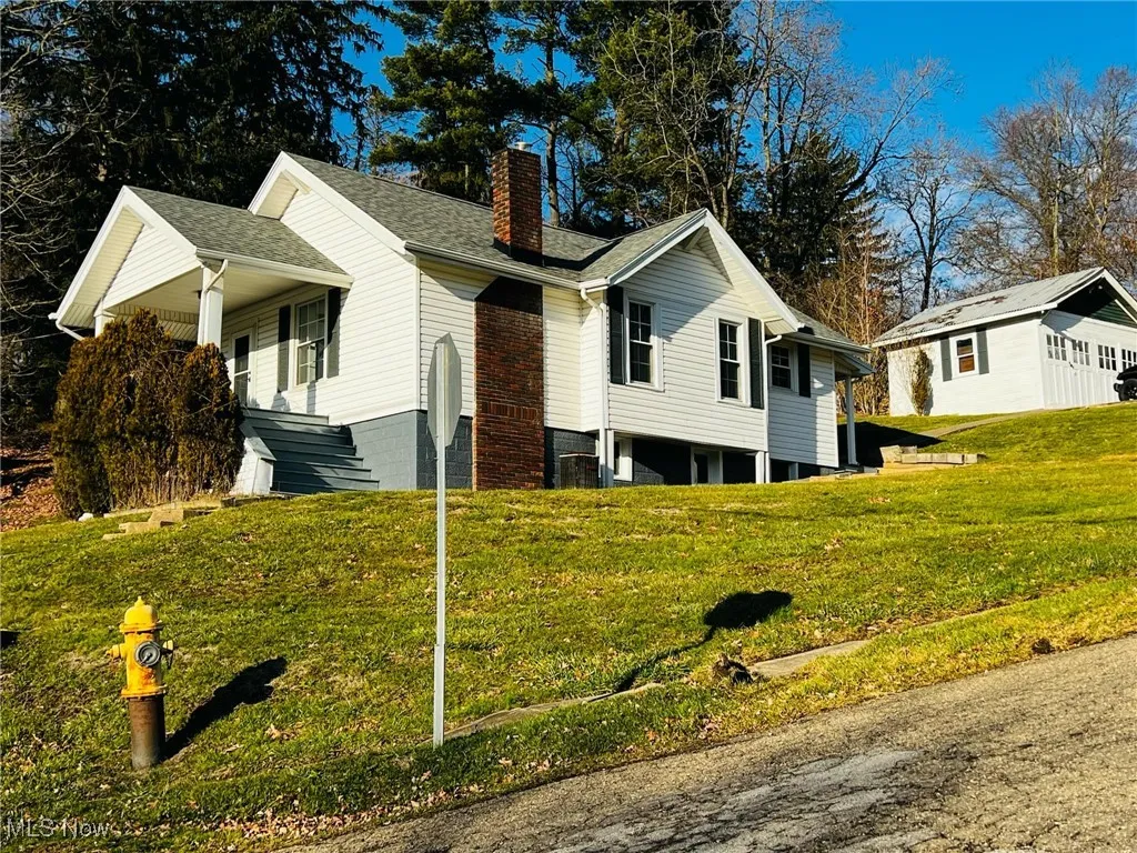 View of side of property featuring a yard