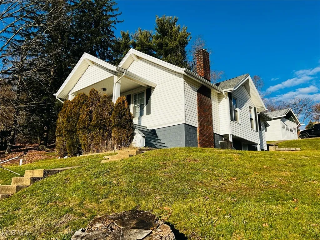 View of property exterior with a lawn