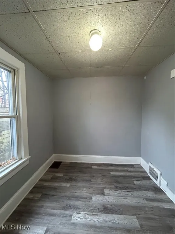 Spare room with dark hardwood / wood-style flooring