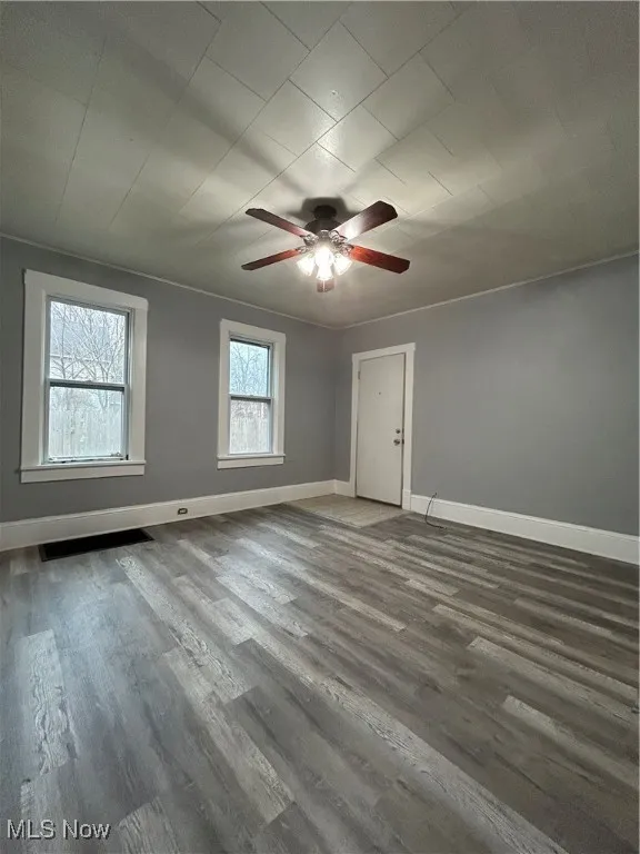 Bonus room with dark hardwood / wood-style flooring