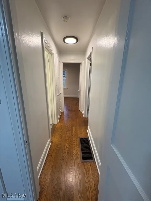 Hallway with hardwood flooring