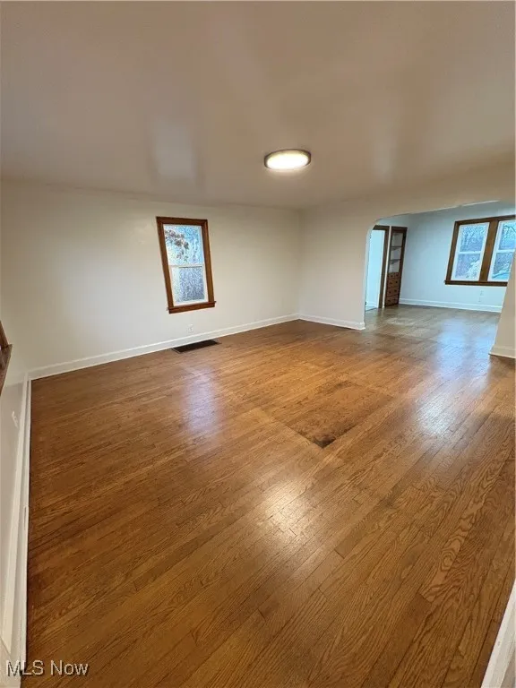 Room featuring plenty of natural light and wood-type flooring