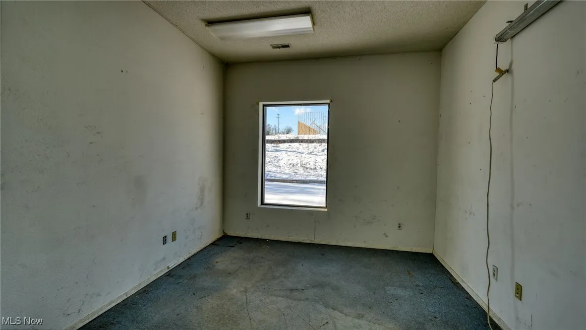 Spare room with a textured ceiling