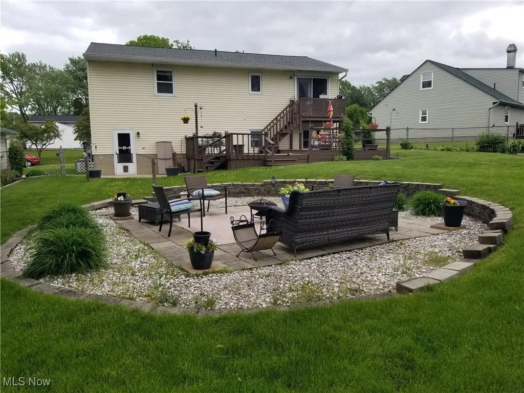 Rear elevation of the home with the fire pit circle in tje forebround
