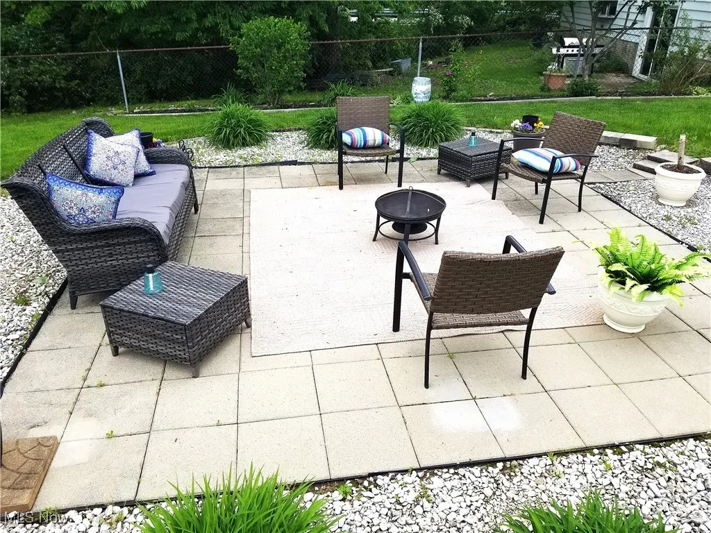 Rear view of the circle patio with a fire pit