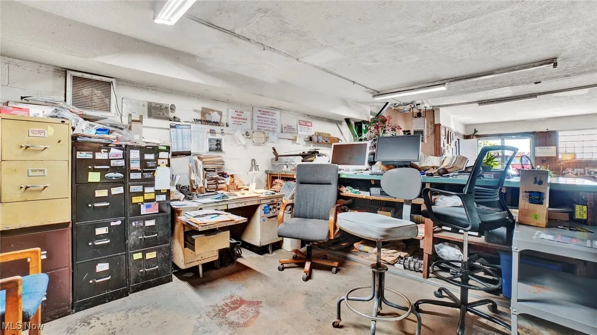 Office space featuring a workshop area and concrete flooring