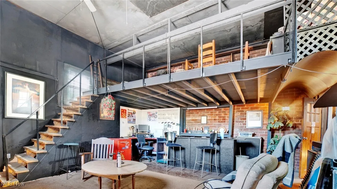 Living room featuring bar and concrete flooring