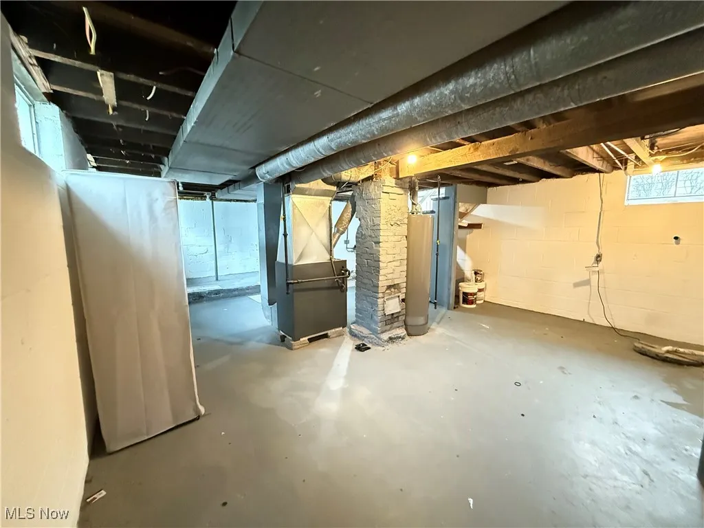 Below grade area with heating unit and gas water heater