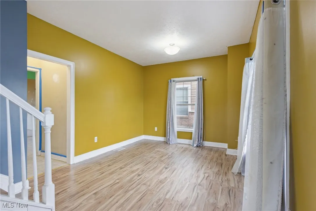 Empty room with light hardwood / wood-style flooring