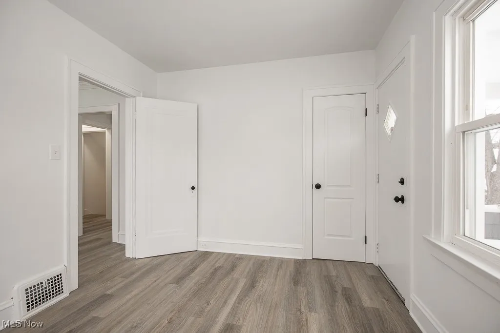 Unfurnished room featuring hardwood / wood-style flooring and plenty of natural light