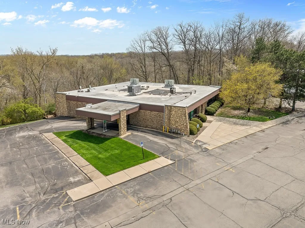 Birds eye view of property with a wooded view