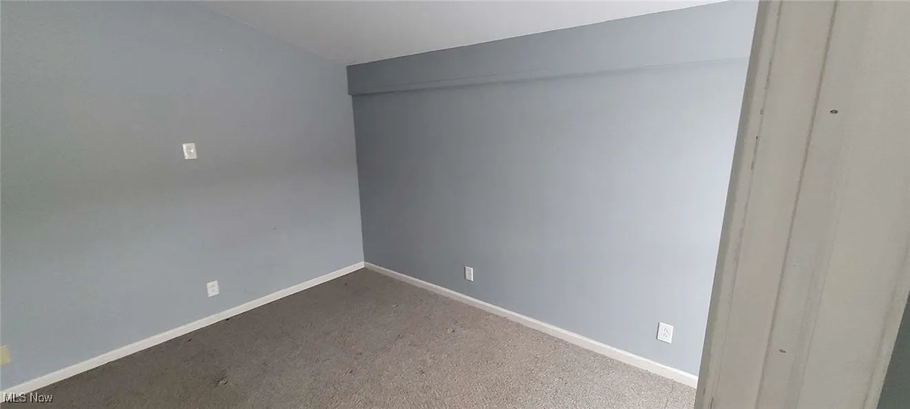 Unfurnished room with carpet floors