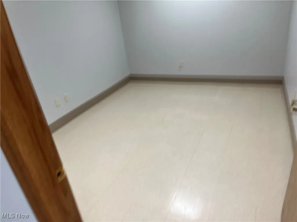 Unfurnished room with baseboards
