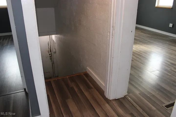 Stairway featuring hardwood / wood-style floors