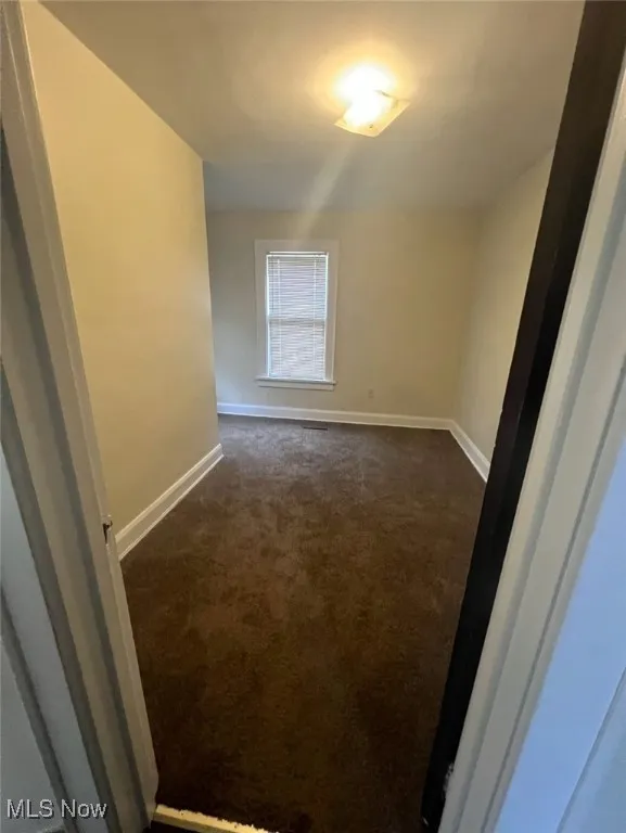 Empty room with dark carpet