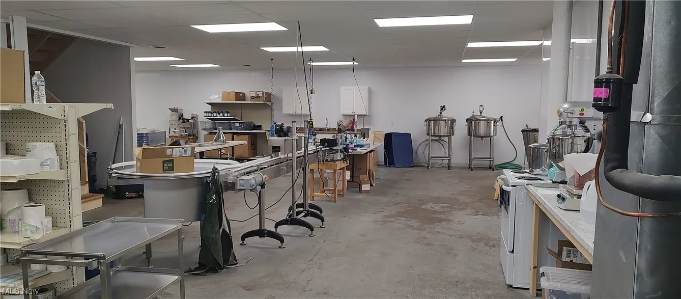 Miscellaneous room featuring a workshop area and a paneled ceiling