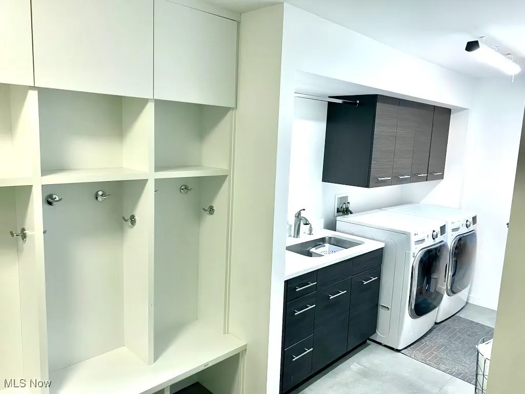 Laundry area with sink, cabinets, and washer and dryer