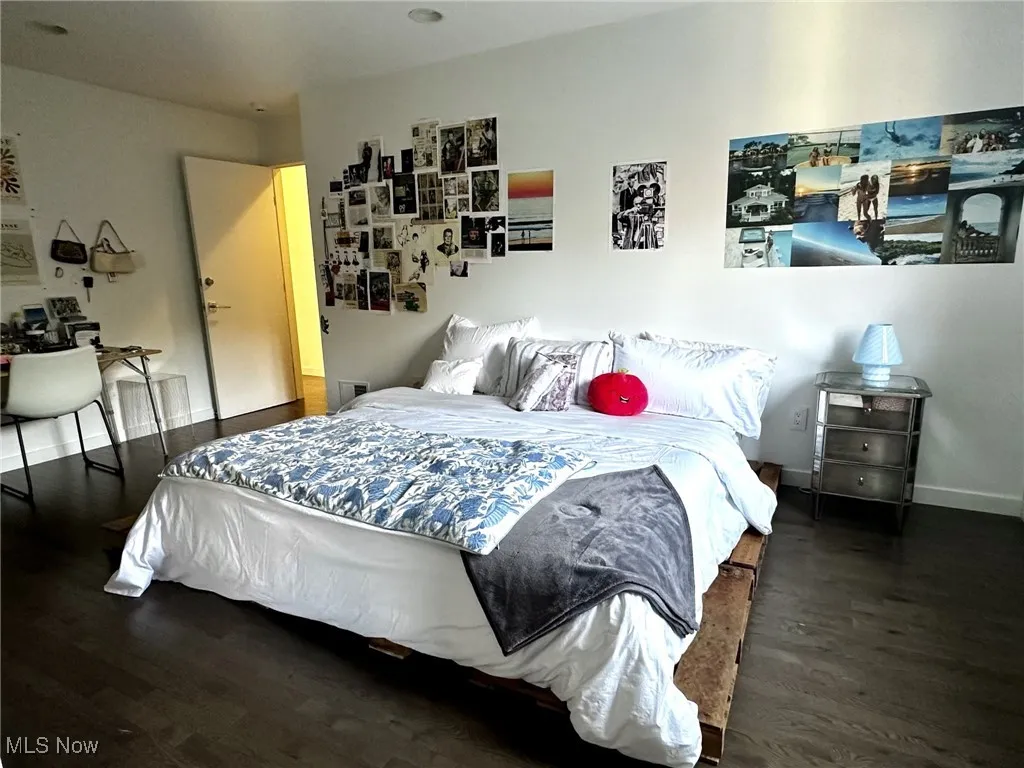Bedroom with dark wood-type flooring