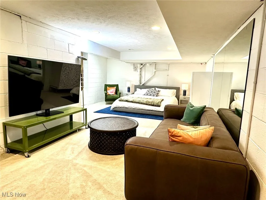 Carpeted bedroom featuring a textured ceiling