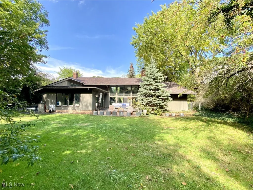Rear view of house featuring a lawn