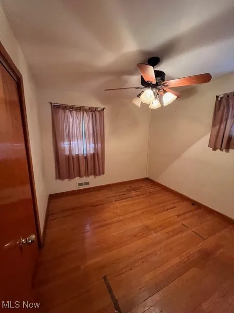 Spare room with ceiling fan and light hardwood / wood-style floors