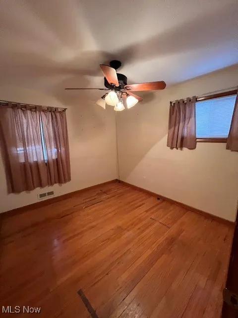 Spare room featuring light hardwood / wood-style floors and ceiling fan