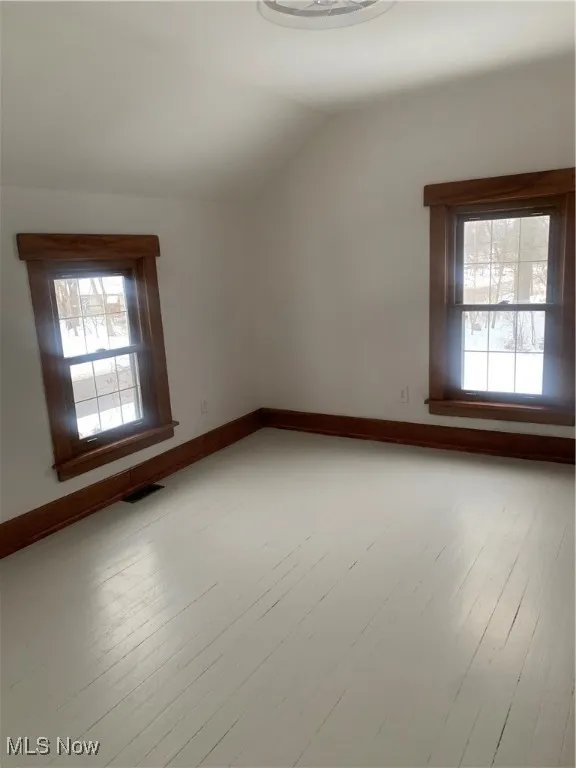 Spare room featuring lofted ceiling