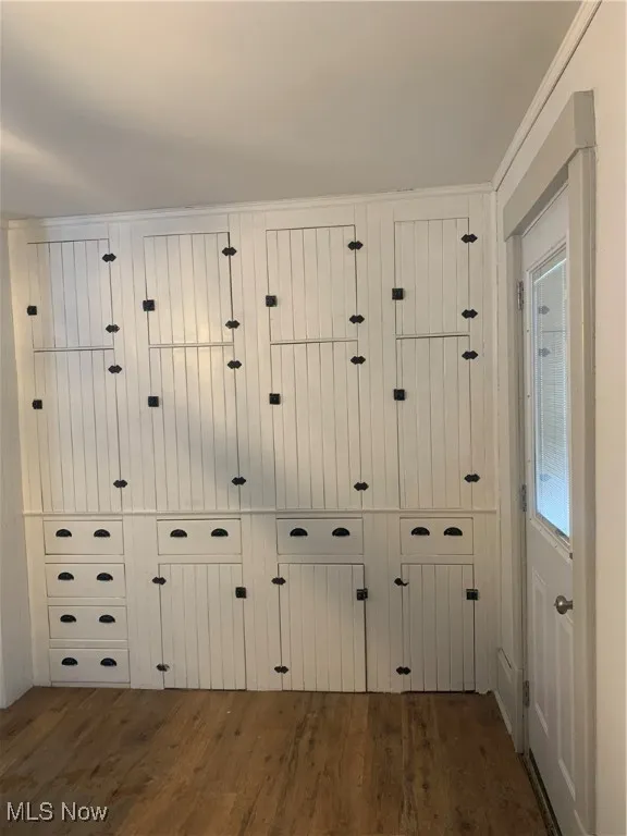 Interior details featuring hardwood / wood-style flooring, ornamental molding, and a mail area