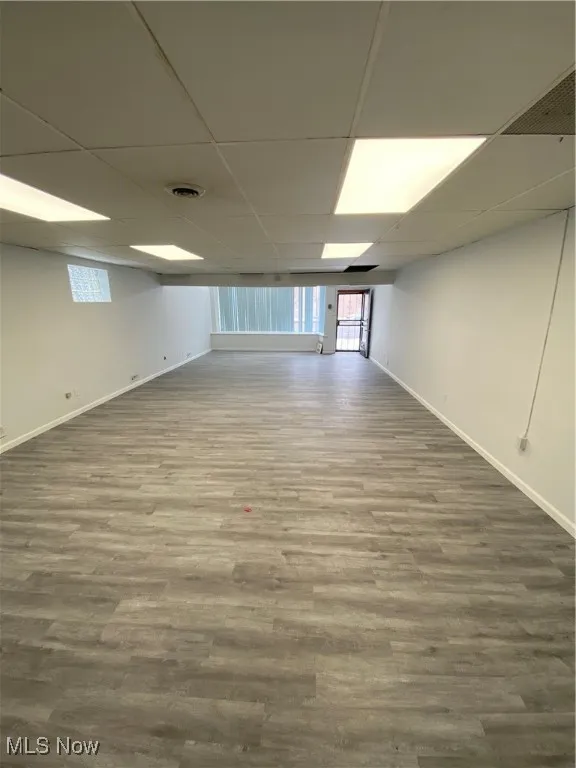 Basement featuring hardwood / wood-style flooring and a drop ceiling