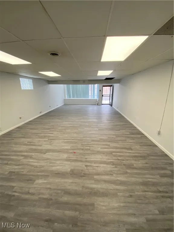 Basement featuring a drop ceiling and wood-type flooring