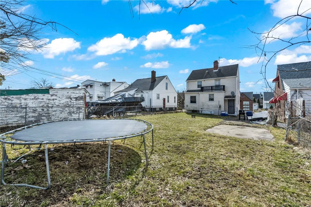 View of yard with a trampoline, a patio area, and a fenced backyard
